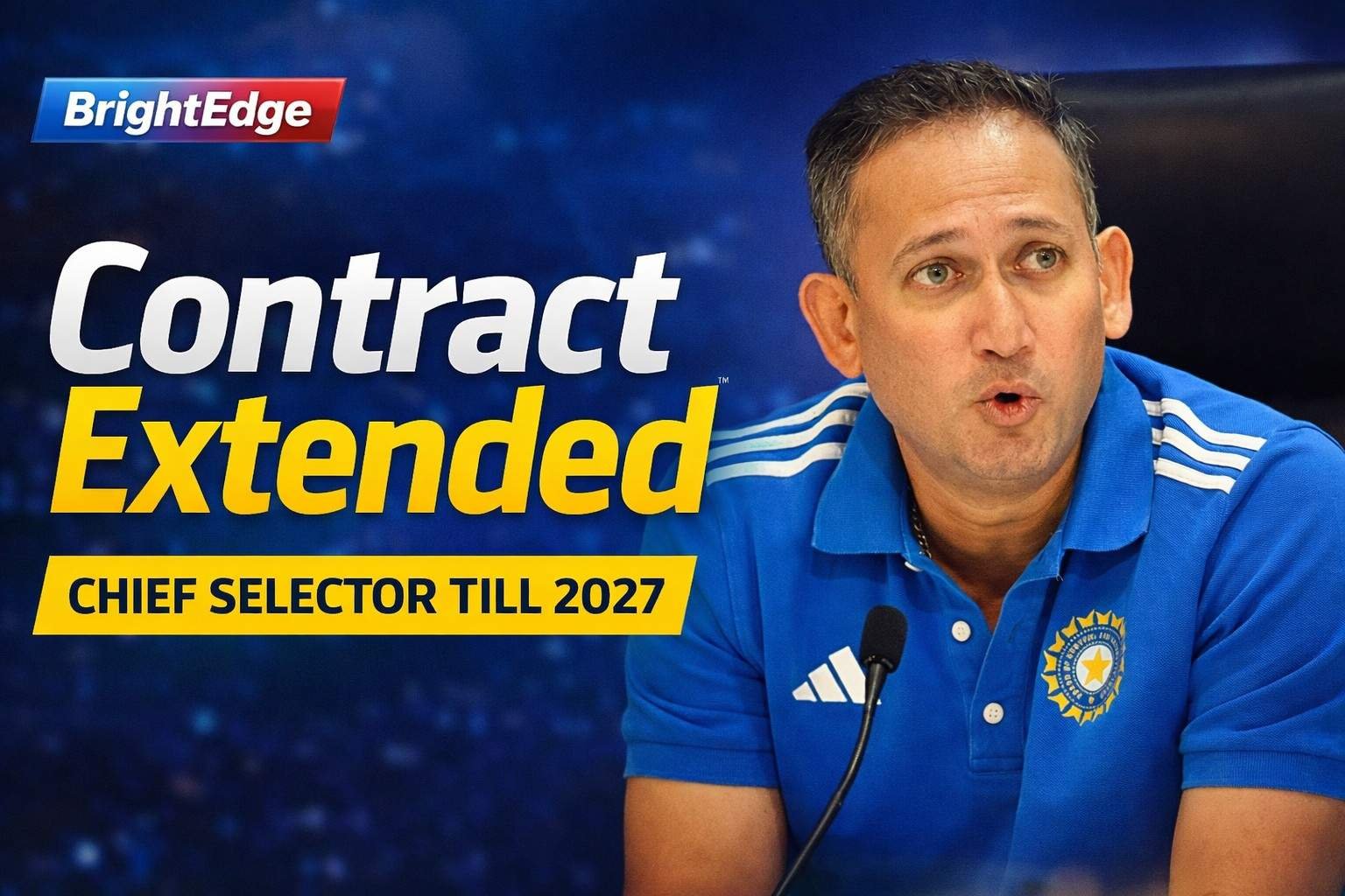 Ajit Agarkar speaking at a press conference wearing a blue India cricket team jersey, with a microphone in front and a blurred blue media backdrop. Bold text overlay reads “Contract Extended” and “Chief Selector Till 2027.